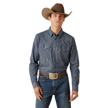 Man wearing a patterned shirt, jeans, and a cowboy hat on a white background