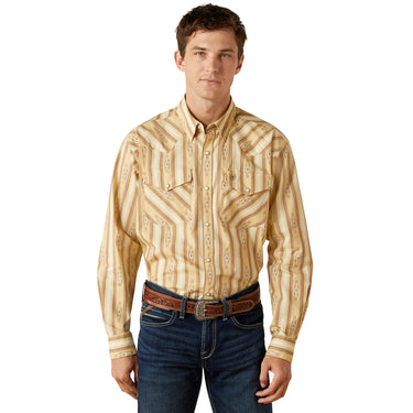 Man wearing a patterned shirt and jeans on a white background