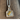 Silver and gold pendant on a chain against a wooden background