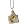 Silver and gold pendant on a chain against a white background