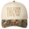 Cap with 'You Look Like You Love Me' text and camouflage brim on a neutral background
